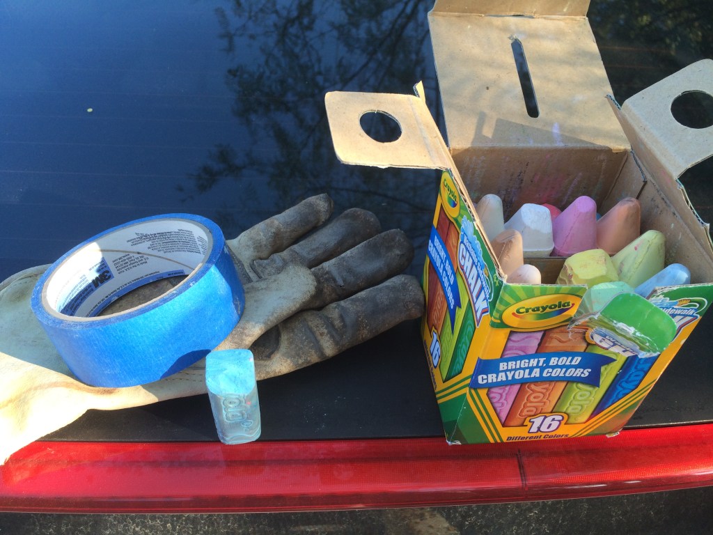 Glove, tape, and chalk on rear end of car