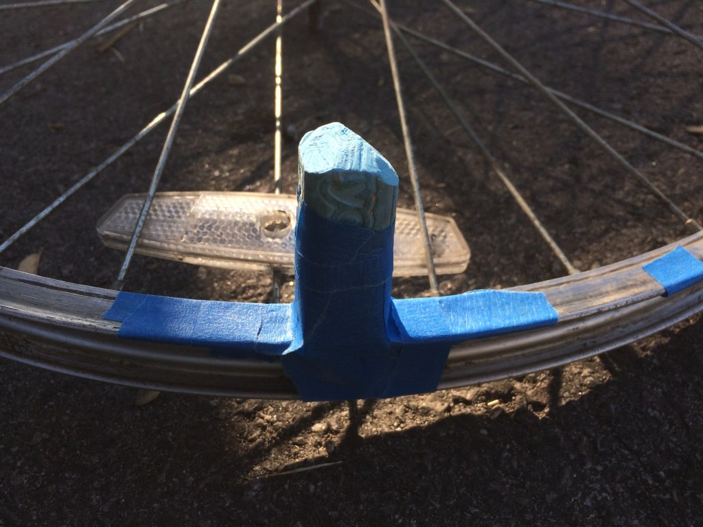 Piece of chalk attached to bicycle wheel