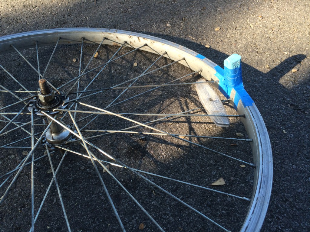 Piece of chalk attached to bicycle wheel